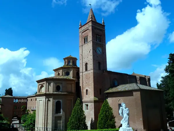 Abbey of Monte Oliveto Maggiore: the church and bell tower among cypresses
